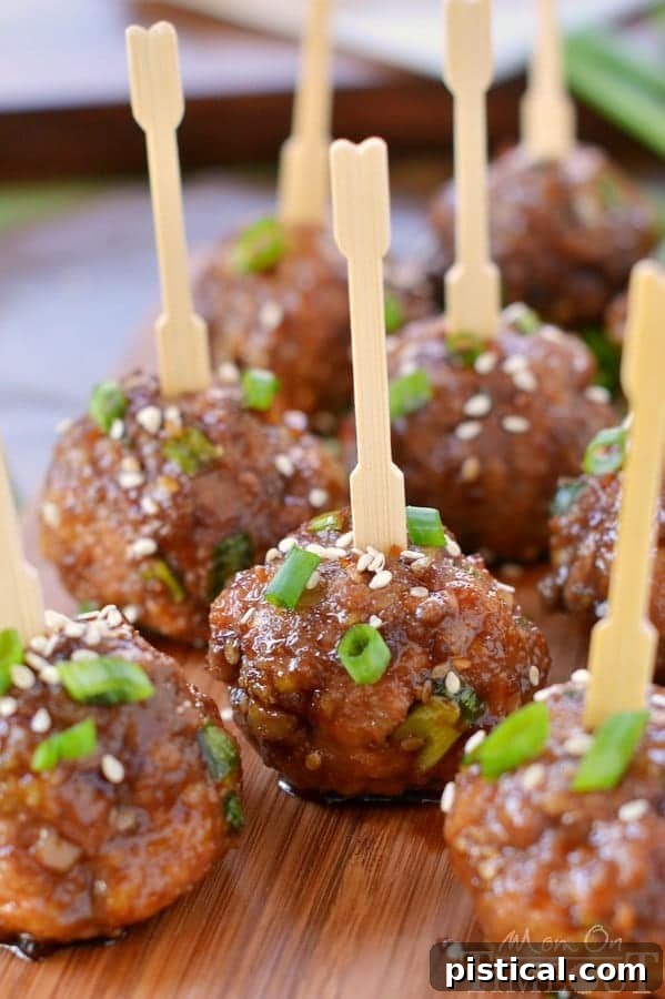 Sticky Teriyaki Meatball Bites 5 Close-up of fully cooked Teriyaki Meatballs garnished with green onions and sesame seeds, ready to be served.