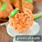 A festive image of delicious Pumpkin Popcorn Balls, soft and chewy, with marshmallow base, ideal for Halloween and Thanksgiving.