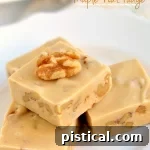 Delicious Maple Nut Fudge with a smooth texture and crunchy walnuts.