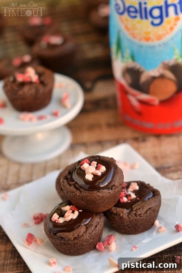 Decadent Peppermint Chocolate Truffle Cups 3 Close-up of freshly baked Peppermint Chocolate Truffle Cookie Cups, showcasing the rich ganache and festive peppermint topping. | YourSite.com | #dessert #Christmas #HolidayTreats