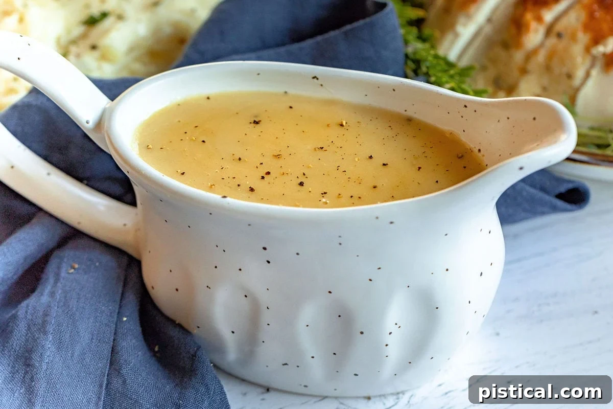 Secrets to Irresistible Turkey Gravy 5 A large, elegant gravy boat filled with perfectly smooth turkey gravy, positioned on a festive table setting, ready to be served to guests.