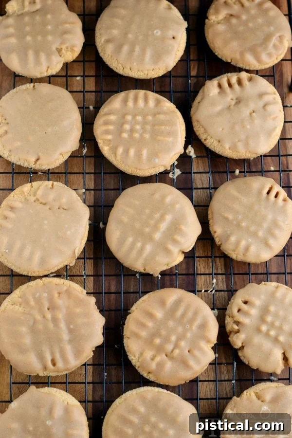 Perfectly glazed peanut butter cookies, a delightful holiday treat Maple cinnamon glazed peanut butter cookies cooling on a wire rack