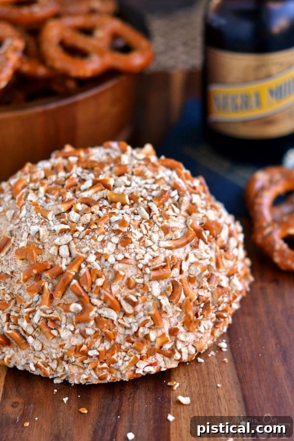 Irresistible Bacon Ranch Beer Cheeseball, coated in pretzel crumbs and ready to be served as an appetizer.