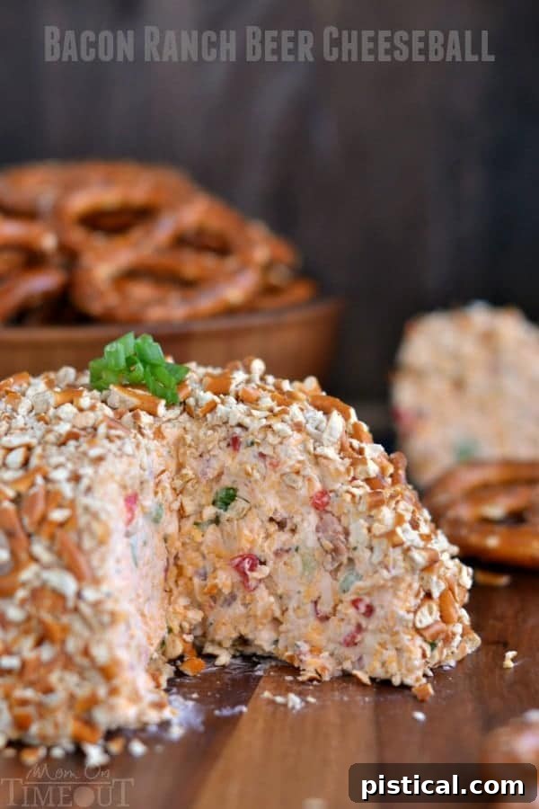 Close-up of the delicious Bacon Ranch Beer Cheeseball, showcasing its pretzel crumb coating and savory texture.