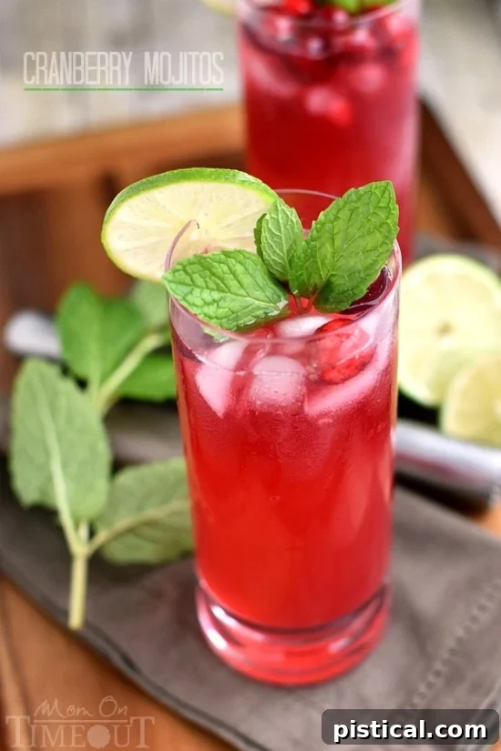 Ruby Red Refresher 3 Close-up shot of a Cranberry Mojito, highlighting the vibrant color and refreshing ingredients like mint, lime, and cranberries. A perfect holiday beverage.