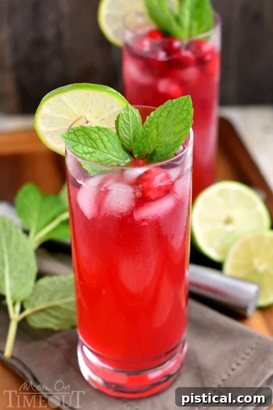 Ruby Red Refresher 5 Several glasses of Cranberry Mojitos, ready to be served at a holiday party. The drinks are garnished with fresh cranberries, mint, and lime, showcasing their festive appeal.