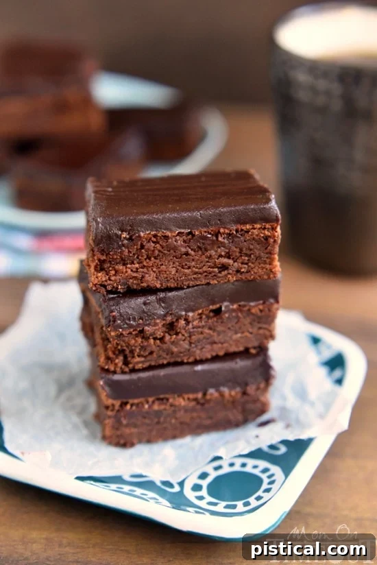 Close-up shot of rich Mocha Truffle Brownies, showing the fudgy texture and glossy chocolate ganache topping. Perfect for dessert.