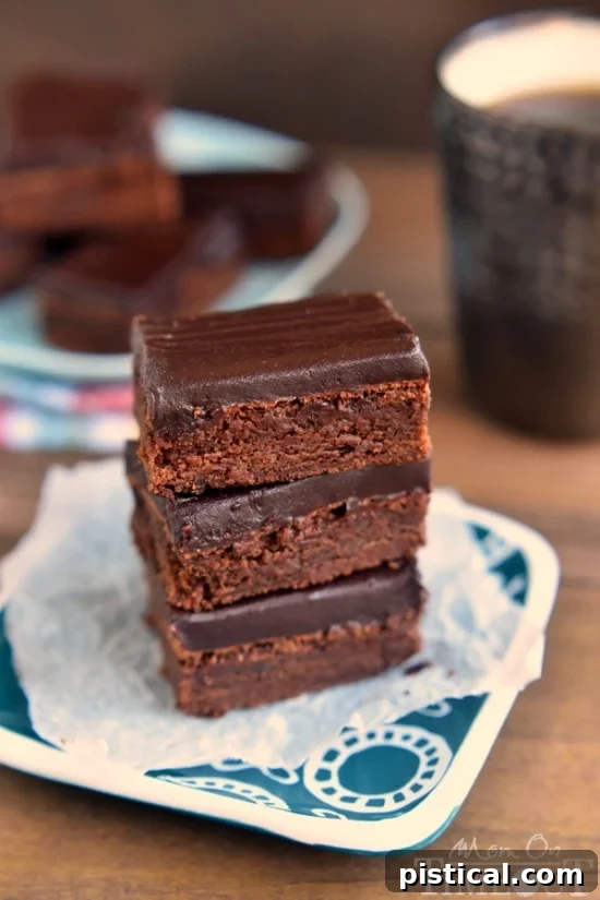 Stack of Mocha Truffle Brownies showcasing the thick ganache layer and rich brownie base. A perfect chocolate dessert bar.