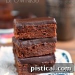 A stack of mocha truffle brownies on a blue and white plate, ready to be enjoyed.