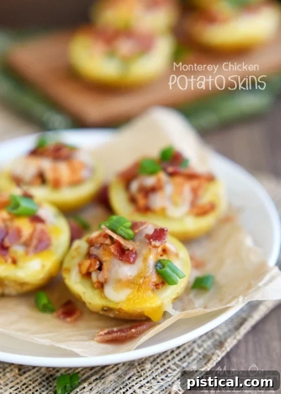 Close-up of golden brown Monterey Chicken Potato Skins topped with melted cheese, bacon, and green onions.