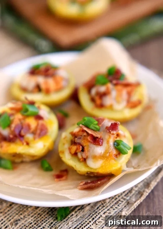A tray of freshly baked Monterey Chicken Potato Skins garnished with green onions and bacon bits.