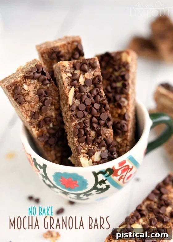 Rich Mocha No-Bake Energy Bars 3 Close-up of freshly made Mocha No-Bake Granola Bars with a generous sprinkling of mini chocolate chips, highlighting their appealing texture and rich color. A perfect, energizing snack for any time of day. | MomOnTimeout.com