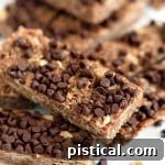 A close-up of a single Mocha No Bake Granola Bar, showcasing its texture and delicious chocolate topping.