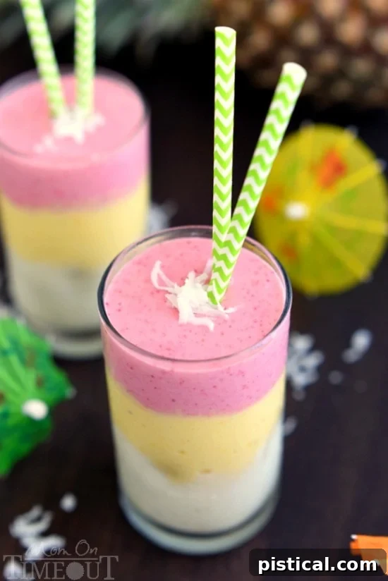 A top-down view of two Tropical Sunrise Smoothies, highlighting the distinct and colorful fruit layers.