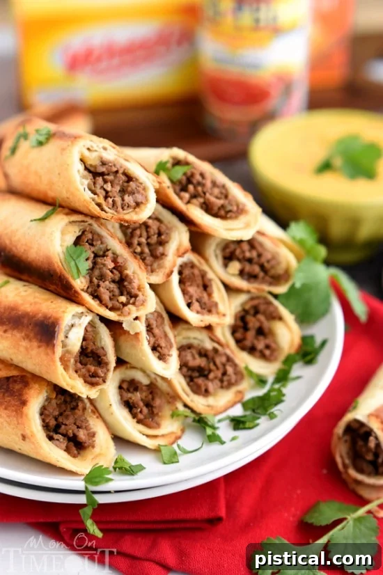 A party platter featuring a full spread of baked beef flautas, ready for guests to enjoy with the accompanying warm queso dip.