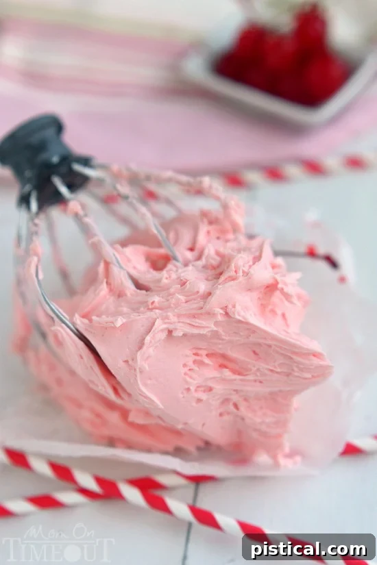 A tray of freshly baked cookies generously topped with homemade Maraschino Cherry Frosting, garnished with whole cherries.