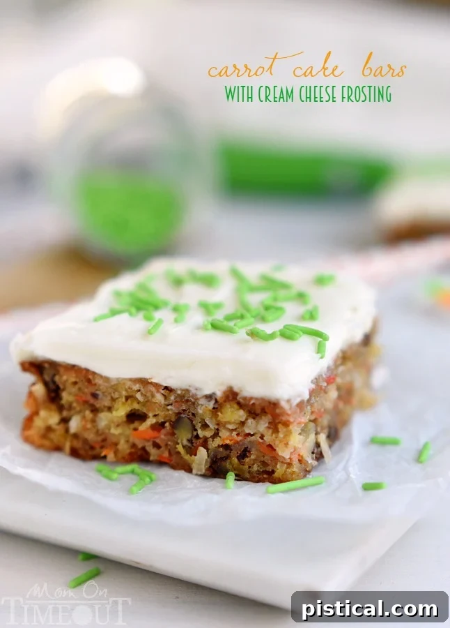 Close-up of perfectly frosted Carrot Cake Bars, showing the moist texture and thick cream cheese topping.