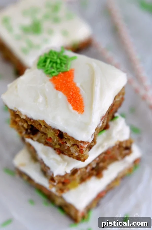 Carrot Cake Bars decorated with charming little candy carrots on top of the cream cheese frosting.
