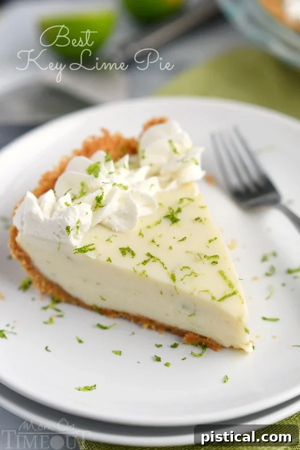 The Best Key Lime Pie: Tart and Sweet Perfection The Best Key Lime Pie - A visually stunning whole pie with a golden graham cracker crust and smooth, pale green filling, garnished with fresh lime zest.