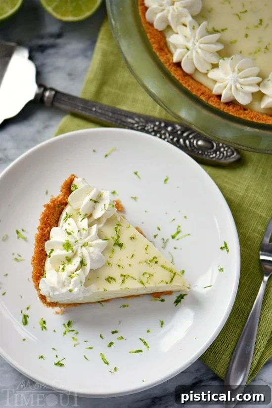 Key Lime Pie Slice: Irresistibly Delicious A delectable slice of Key Lime Pie, perfectly cut to reveal its distinct layers: a golden graham cracker crust, a smooth, pale green filling, and a fluffy white whipped cream topping.
