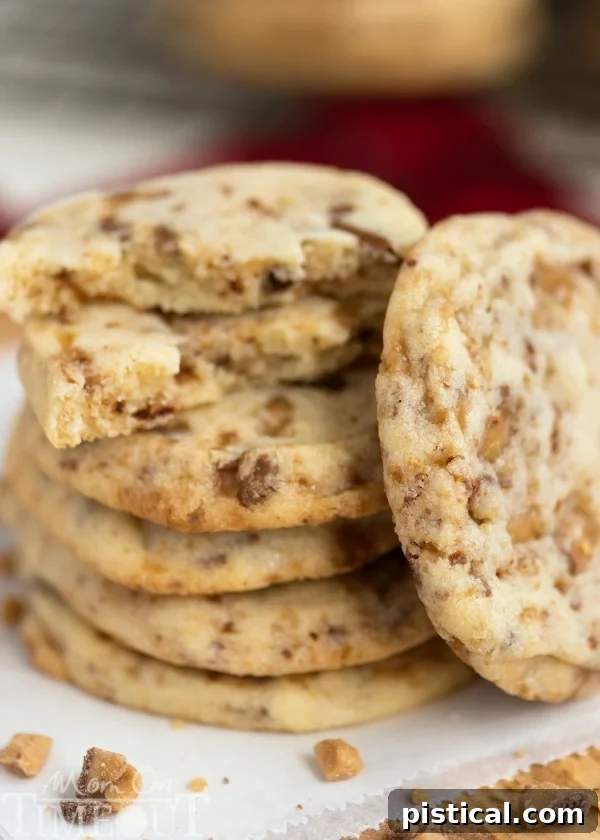 Freshly baked Toffee Butter Icebox Cookies with Heath toffee bits, showcasing their melt-in-your-mouth texture.