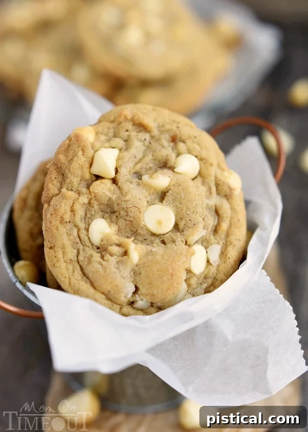 Stack of freshly baked brown butter white chocolate macadamia nut cookies.
