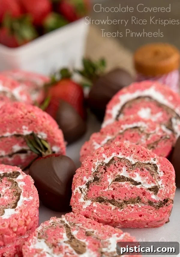 Delicious and pretty Chocolate Covered Strawberry Rice Krispies Treats Pinwheels, perfect for parties and picnics. This easy, pink dessert will be a family favorite. A MomOnTimeout.com recipe.