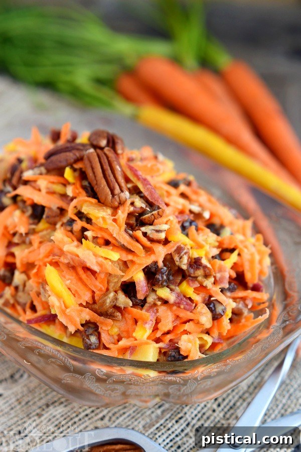 Close-up of the refreshing 5 Minute Rainbow Carrot Pecan Salad, highlighting the mix of colorful carrots, sweet pineapple, and crunchy pecans. A perfect sweet and healthy side for any summer gathering.