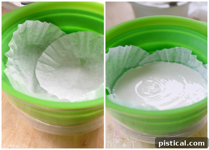Yogurt straining in a colander lined with coffee filters.