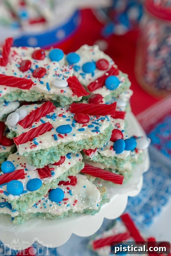 Kids' hands covered in blue Rice Krispies Treats mixture, illustrating the fun and mess of making the patriotic bark.