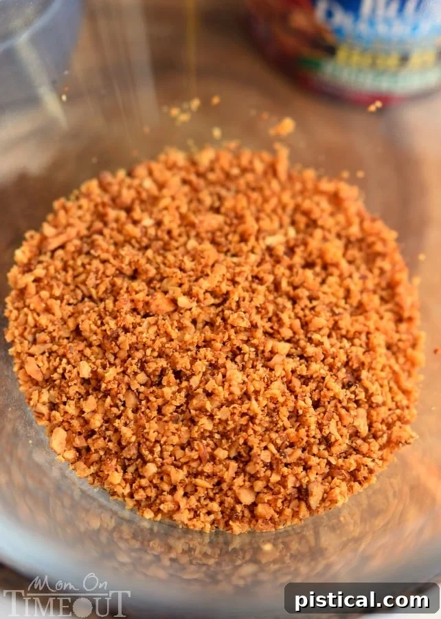 Finely processed Sriracha Blue Diamond almonds in a clear bowl, ready for the next step in the recipe.