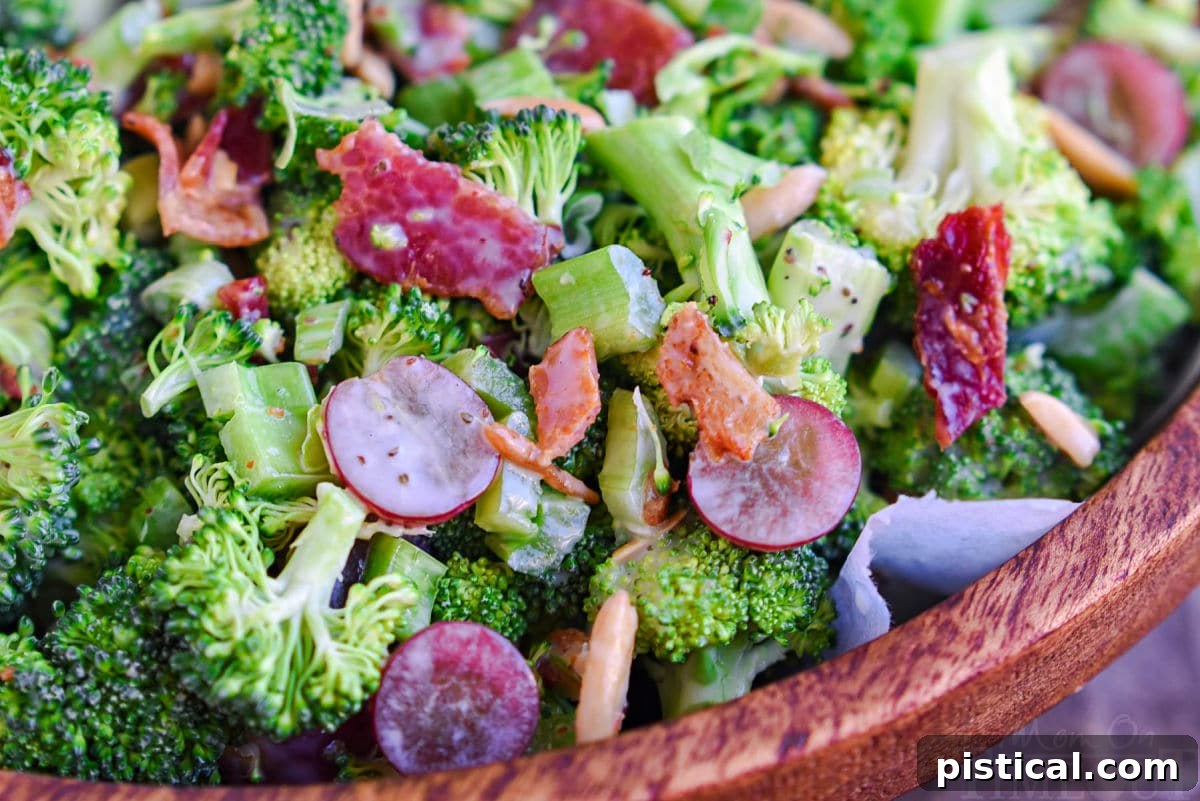 close up view of broccoli salad made with red grapes, bacon, celery and a tangy dressing.