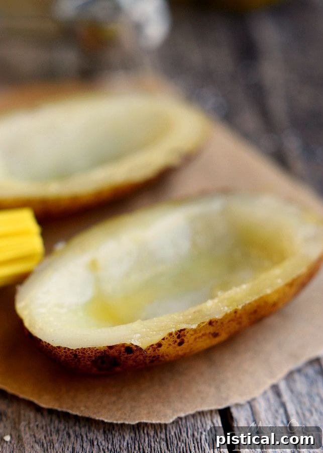 Fresh russet potatoes seasoned and ready for grilling, forming the base of a hearty meal.