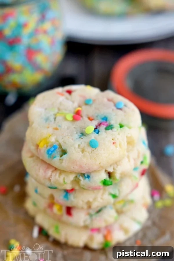 Batch of colorful Funfetti Cake Mix Cookies cooling on a wire rack after baking.