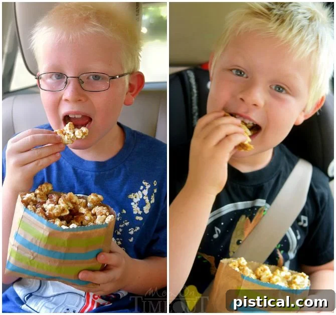 Two boys happily eating Salted Caramel Popcorn with Almonds from a large bowl, showcasing a perfect family snack.