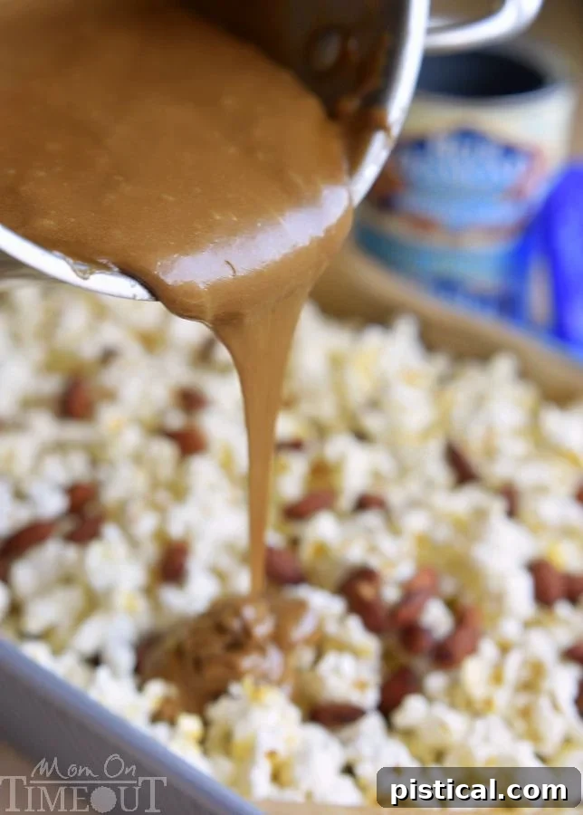 A generous serving of homemade Salted Caramel Popcorn with Almonds, showcasing its golden caramel coating and crunchy texture.