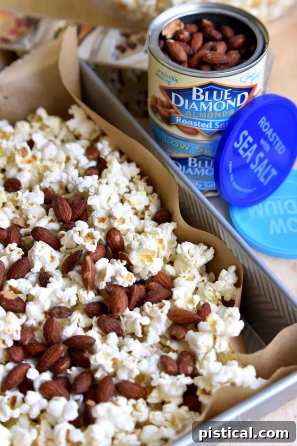 A close-up shot of the irresistible Salted Caramel Popcorn with Almonds, highlighting the glossy caramel and whole almonds.
