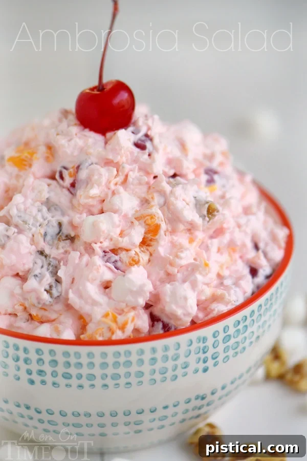 A bowl of easy Ambrosia Salad, showcasing its inviting creamy texture and colorful mix of fruits, marshmallows, and coconut, highlighting its appeal as a simple yet satisfying dessert.