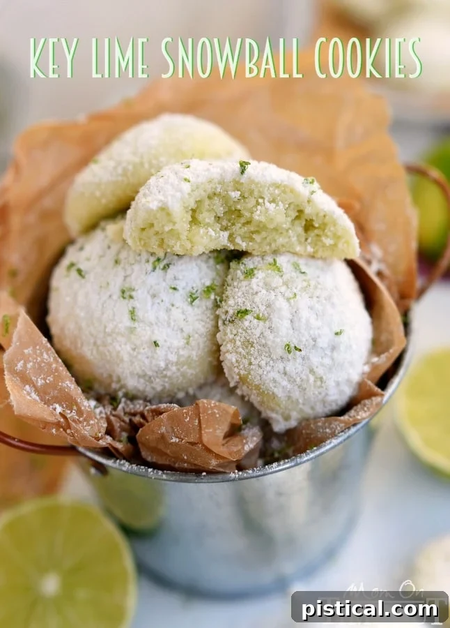 Tangy Key Lime Melt-Aways 2 Delicious and easy Key Lime Snowball Cookies, dusted with powdered sugar, on a cooling rack.