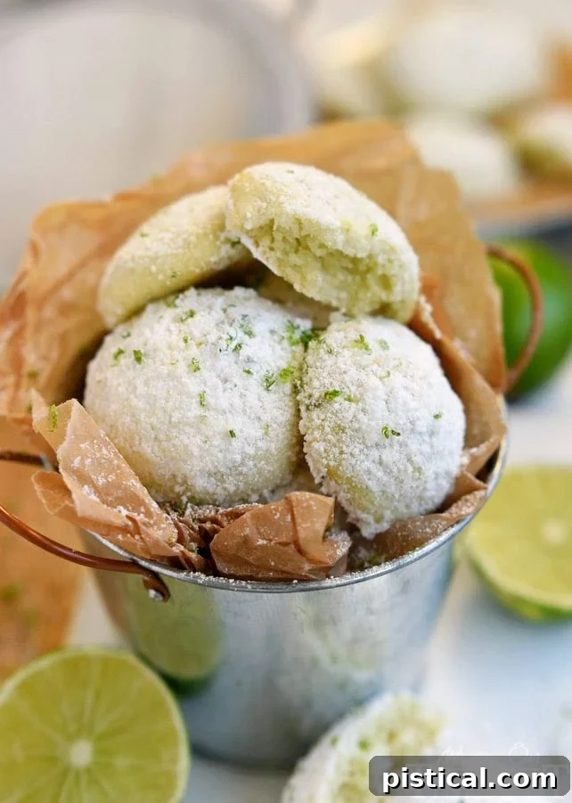 Tangy Key Lime Melt-Aways 4 Freshly baked Key Lime Snowball Cookies generously dusted with powdered sugar.