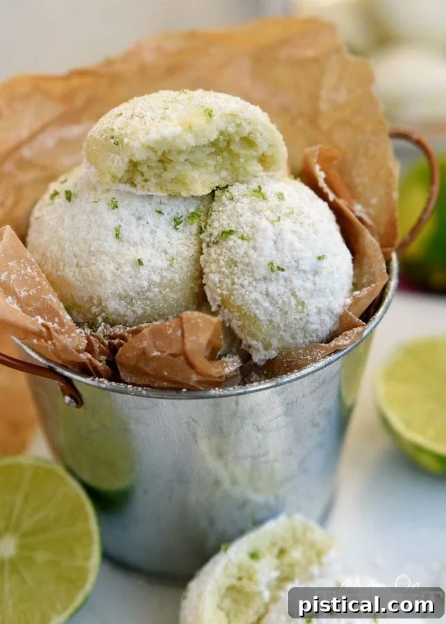 Tangy Key Lime Melt-Aways 5 A plate piled high with Key Lime Snowball Cookies, ready to be enjoyed.