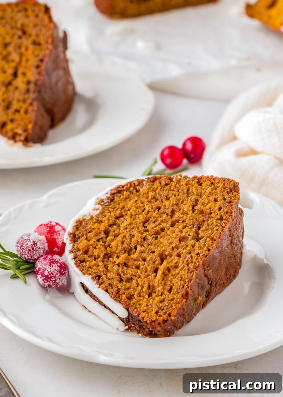 Cozy Gingerbread Bundt Delight 3 A perfectly baked slice of gingerbread bundt cake, showing its moist interior and delicious icing, on a pristine white plate.