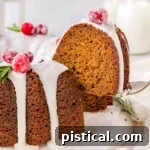 A spatula holding a piece of gingerbread bundt cake above the rest of the cake.