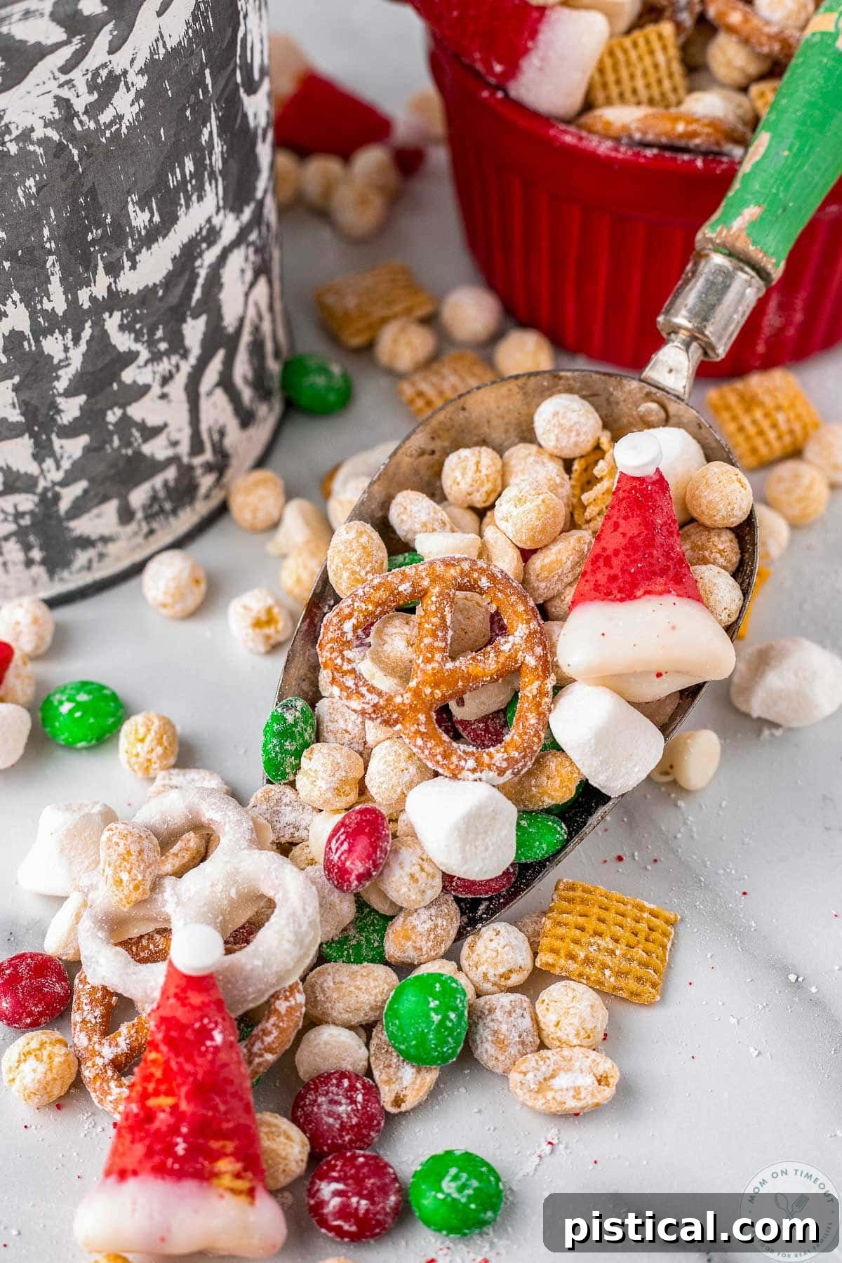 A vintage scoop with a green handle, elegantly presenting a serving of Santa's Christmas Snack Mix, highlighting its delicious and festive components.
