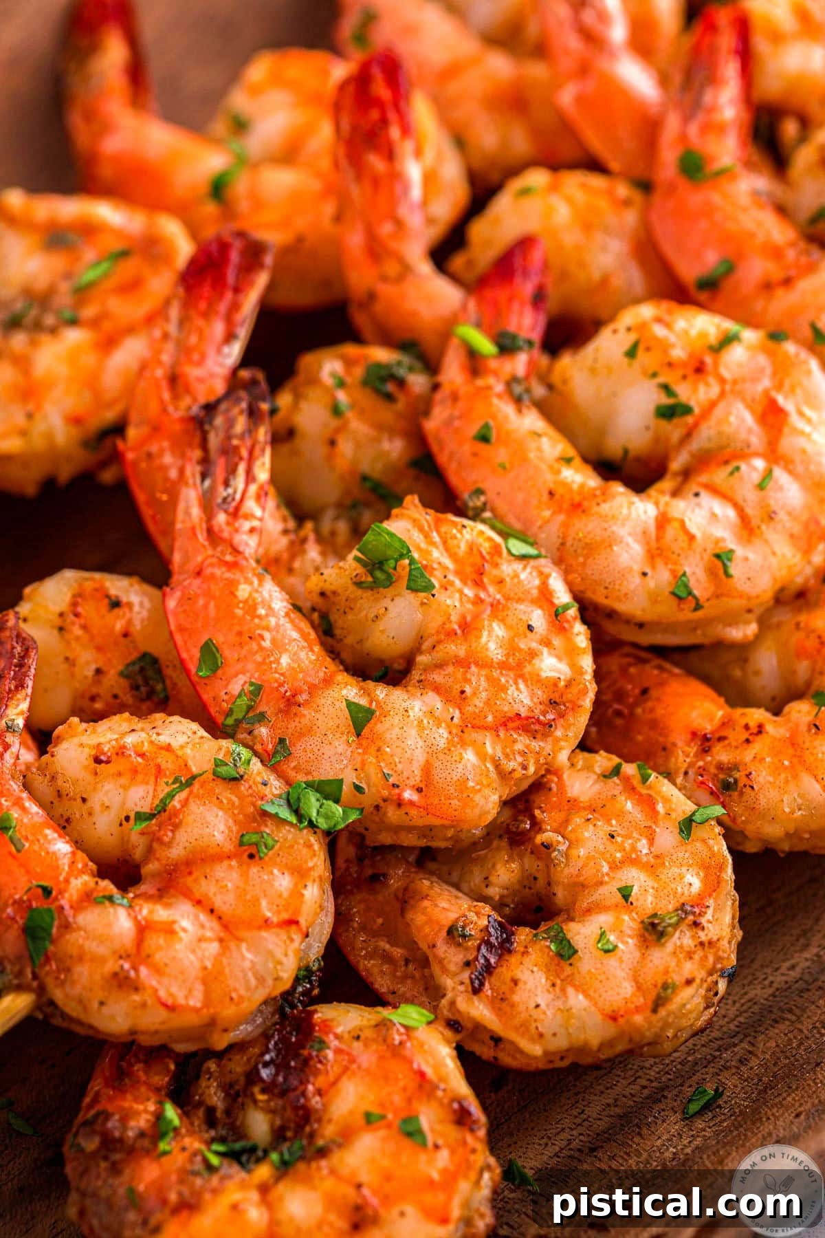 Cajun Shrimp grilled and served on skewers garnished with lemon and parsley.