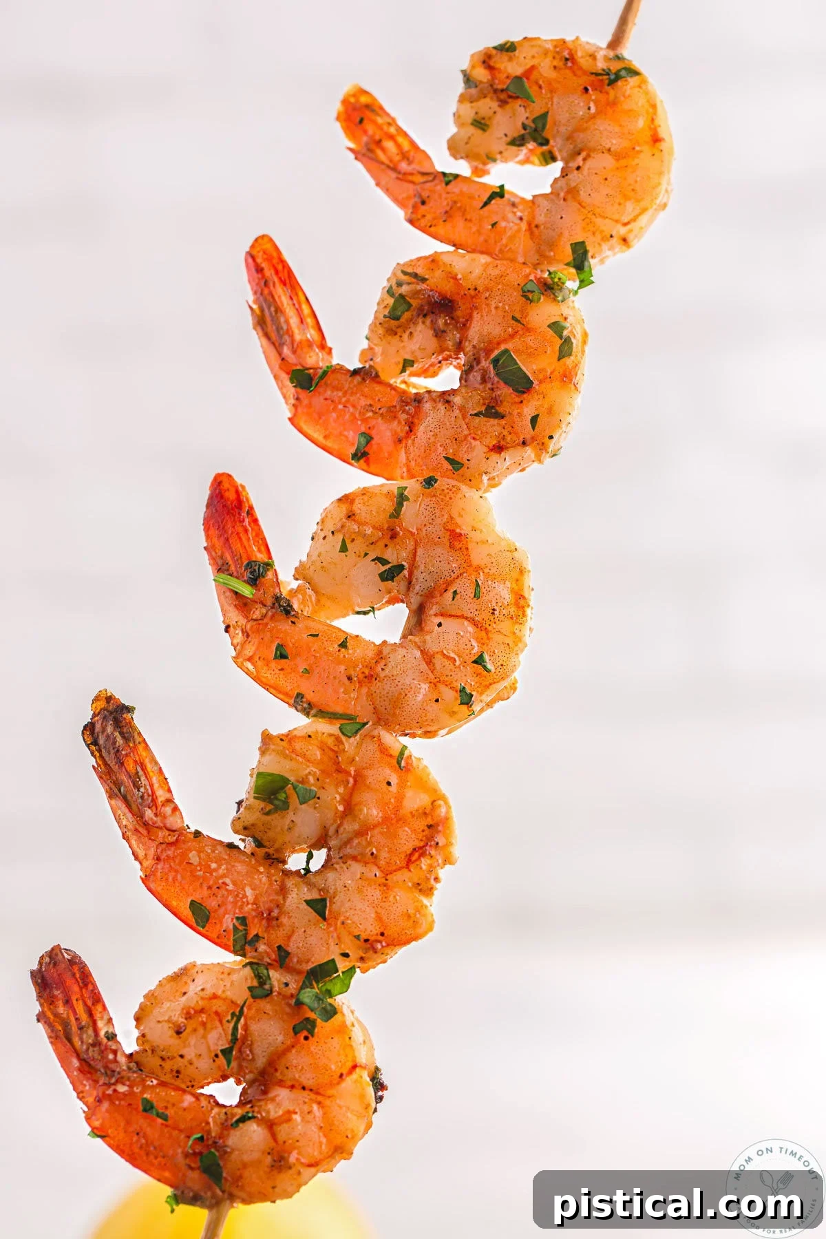 Single skewer with five cajun shrimp on it.