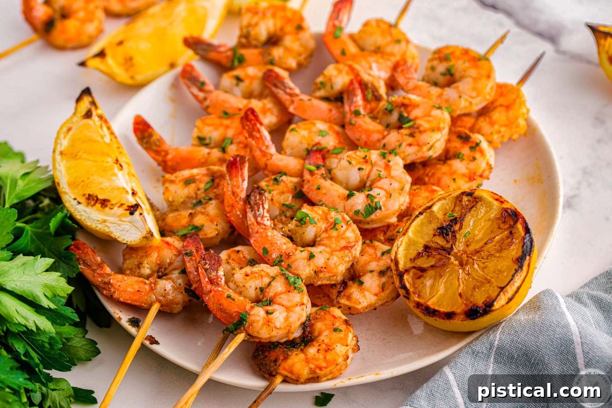 Plate topped with cajun shrimp on skewers ready to be enjoyed. Lemon wedges can be seen in the background.