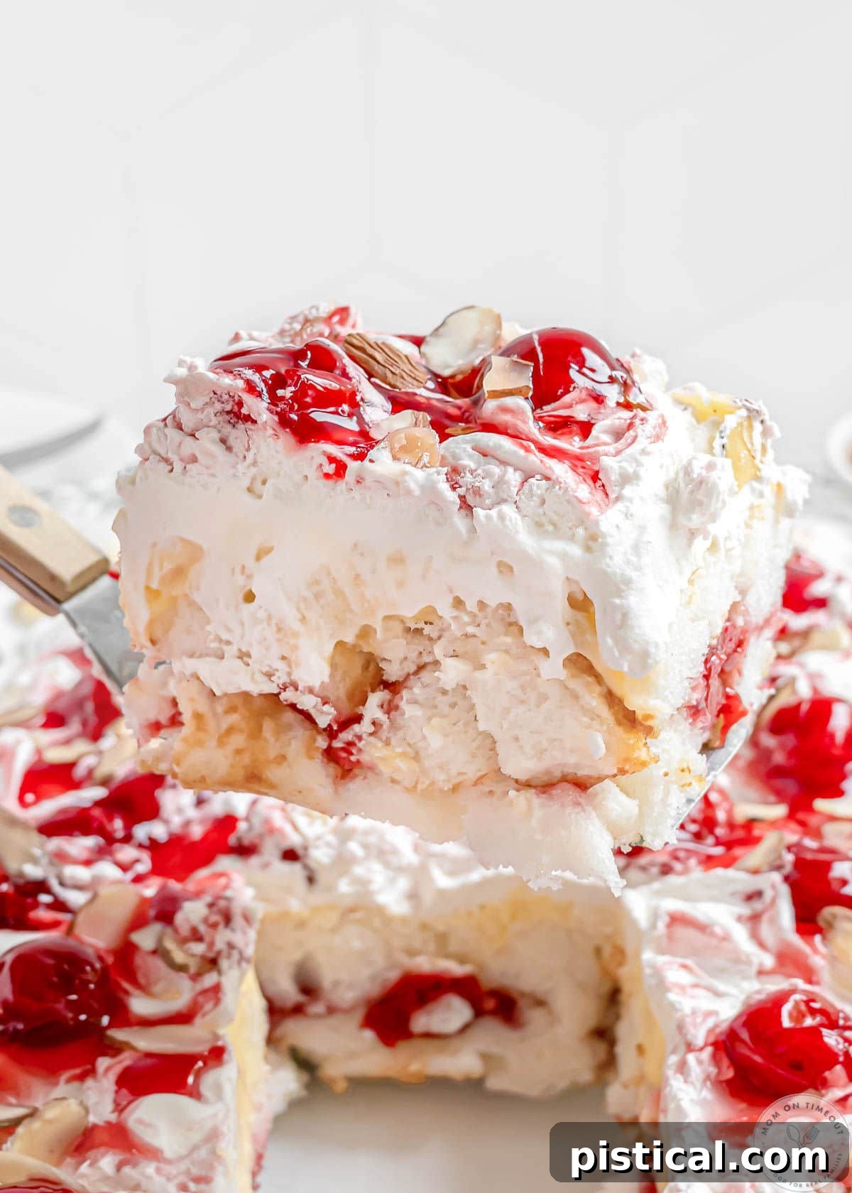 Serving being lifted from baking dish showing layered Heaven On Earth Cake.